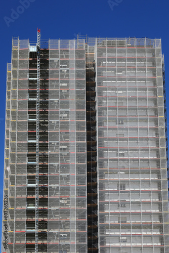 skyscraper during maintenance and installation of insulation panels to safeguard the environment and energy saving