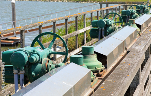 numerous sluice gate valves for water regulation in the flood control basin. photo