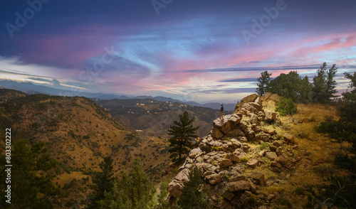 Wallpaper Mural Stunning Mountain Landscape at Sunset with Vibrant Skies with man in jacket overlooking vista Torontodigital.ca