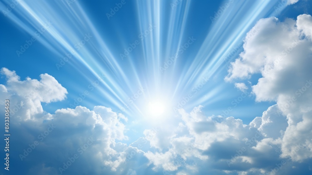 Blue sky with sun rays shining through clouds