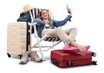 Tourist woman in travel attire, on deck chair with trolley suitcases, make selfie with mobile phone and thumbs-up. Summer beach holiday, flight and vacation travel booking. Travel influencer lifestyle