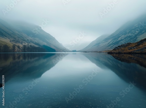 Serene mountain lake landscape with fog and moody atmosphere photo