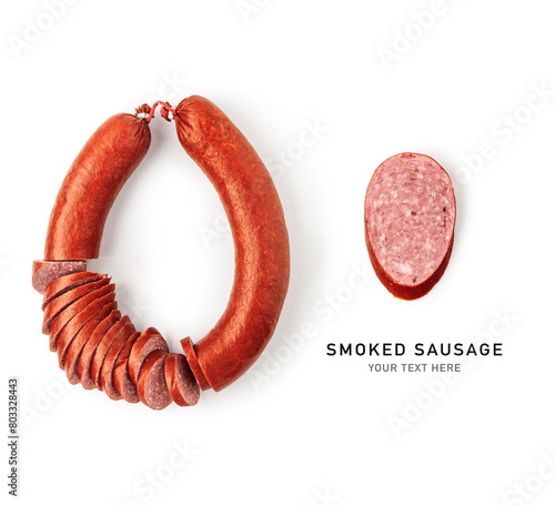 Smoked sausage ring and slice isolated on white background . © ifiStudio