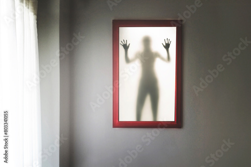surreal picture with a shadow of a man behind the glass surface, abstract concept