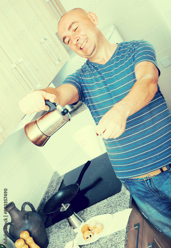 Guy pours coffee into cup of coffee pot Guy pours coffee into cup of coffee pot