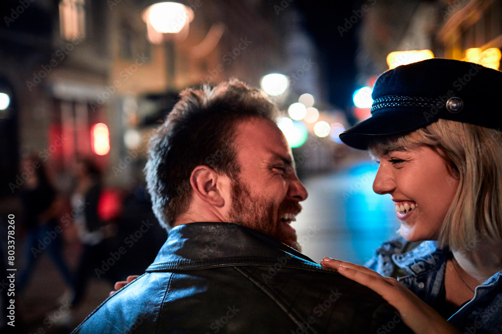 Loving couple enjoying a romantic evening stroll in the city Loving couple enjoying a romantic evening stroll in the city