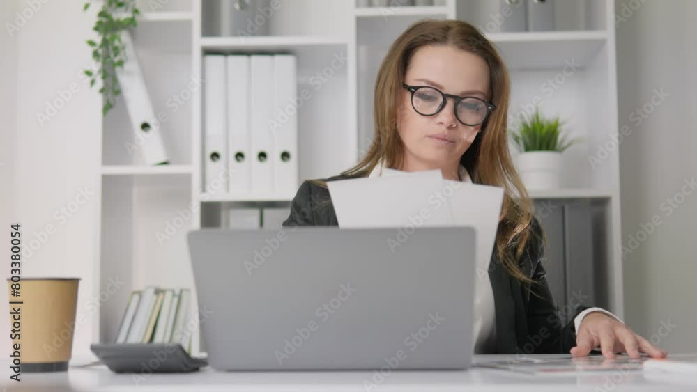 A female entrepreneur solves financial problems and develops her business. A business analyst scrutinizes documents and develops strategies to improve profitability. Business woman in office. A female entrepreneur solves financial problems and develops her business. A business analyst scrutinizes documents and develops strategies to improve profitability. Business woman in office.