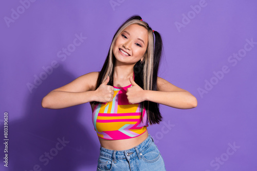 Photo of positive adorable nice girl wear trendy clothes showing thumb up symbol isolated on purple color background