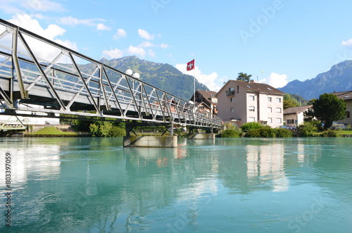 bridge over the river in Switzerland and the Swiss flag