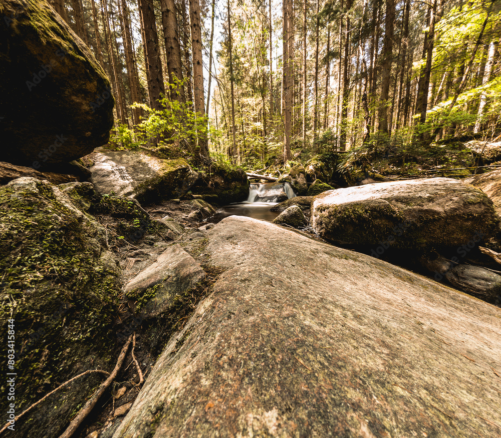 waterfall in forest with rocks and green foliage. waterfall in forest with rocks and green foliage.