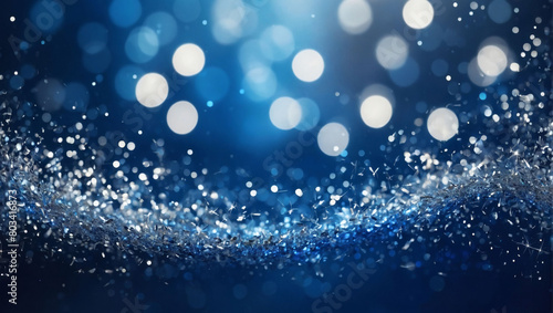 Abstract background with sapphire blue and silver particles. Christmas silver light shine particles bokeh on cobalt backdrop. Silver foil texture. Holiday concept.