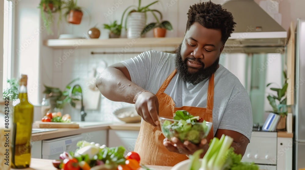 A cheerful bearded Black man preparing a fresh salad in a bright kitchen, surrounded by vegetables. A cheerful bearded Black man preparing a fresh salad in a bright kitchen, surrounded by vegetables.