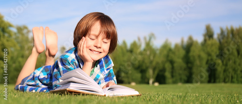 Cute little boy reading boo...