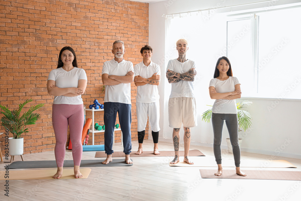 Fototapeta premium Wellness and healthy lifestyle, diverse group of people standing in a yoga studio