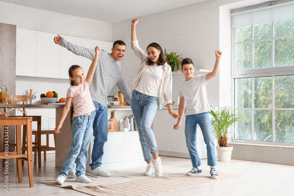 © Pixel-Shot - Happy family dancing in kitchen