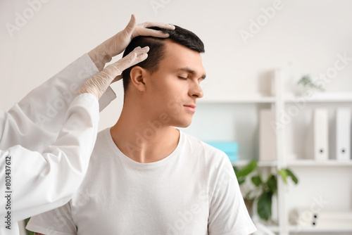 Trichologist examining youn...