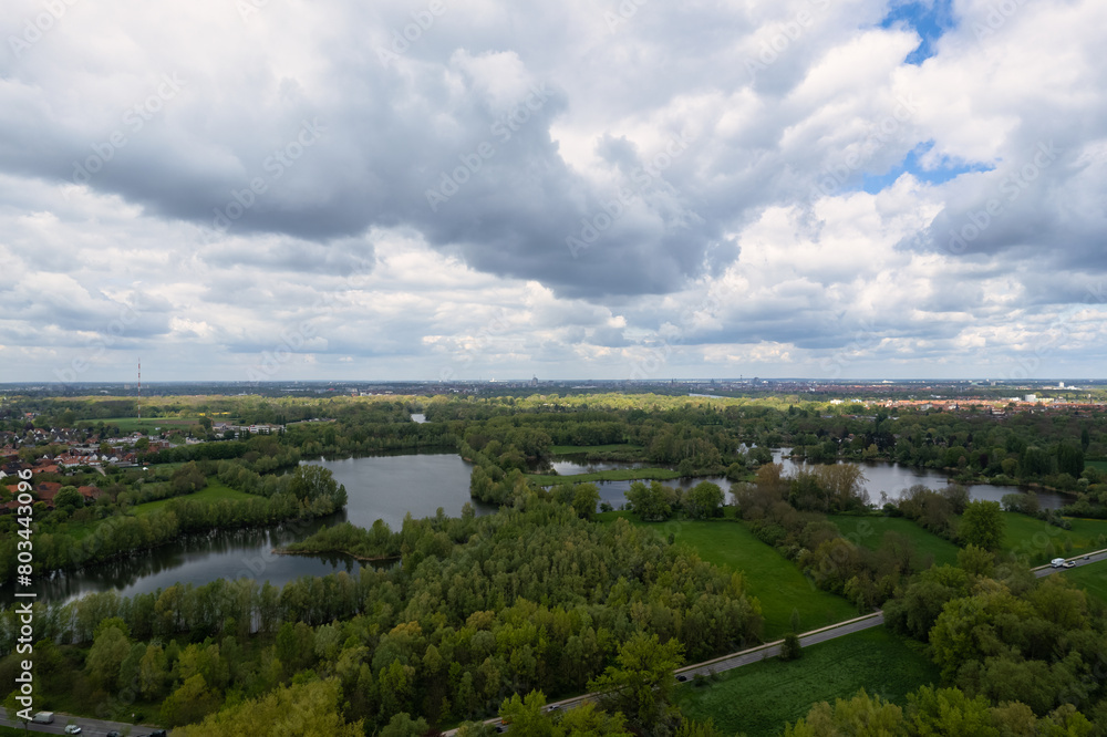 A cloudy day over a lake surrounded by trees, a stunning natural landscape Hanover Ricklinger Teiche Germany