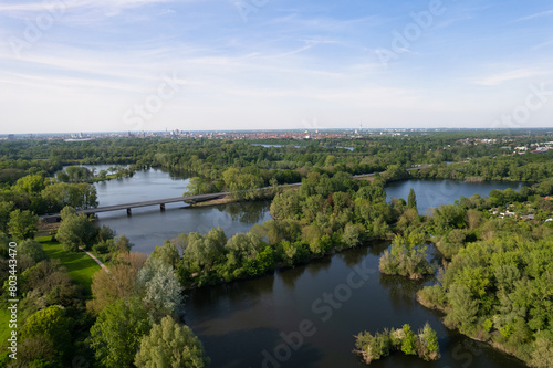 A natural landscape with a river  trees  and a bridge seen from above Hanover Ricklinger Teiche Germany