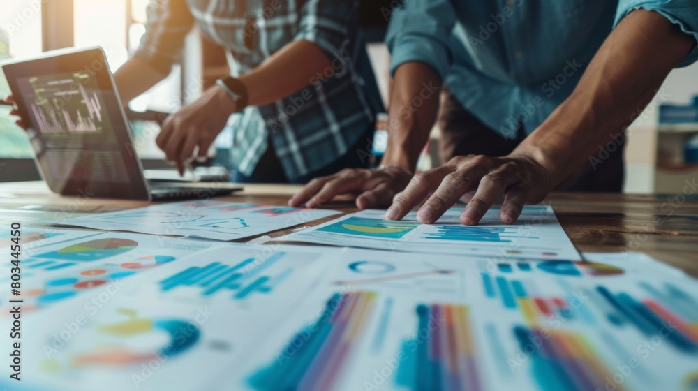 A marketing team analyzing consumer behavior data represented in a graph to develop targeted advertising campaigns. A marketing team analyzing consumer behavior data represented in a graph to develop targeted advertising campaigns.