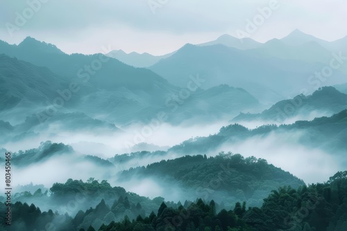 Create a landscape image of a mountain range in the style of Chinese landscape painting. The mountains should be shrouded in mist and the foreground should be obscured by trees.