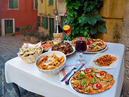 A summer  dinner.Traditional italian food in outdoor restaurant in Trastevere district.Tasty and authentic Italian kitchen.Pasta, pizza  and homemade food arrangement  in Rome, Italy