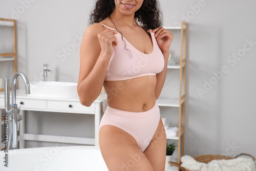 Young woman wearing underwear in bathroom © Pixel-Shot
