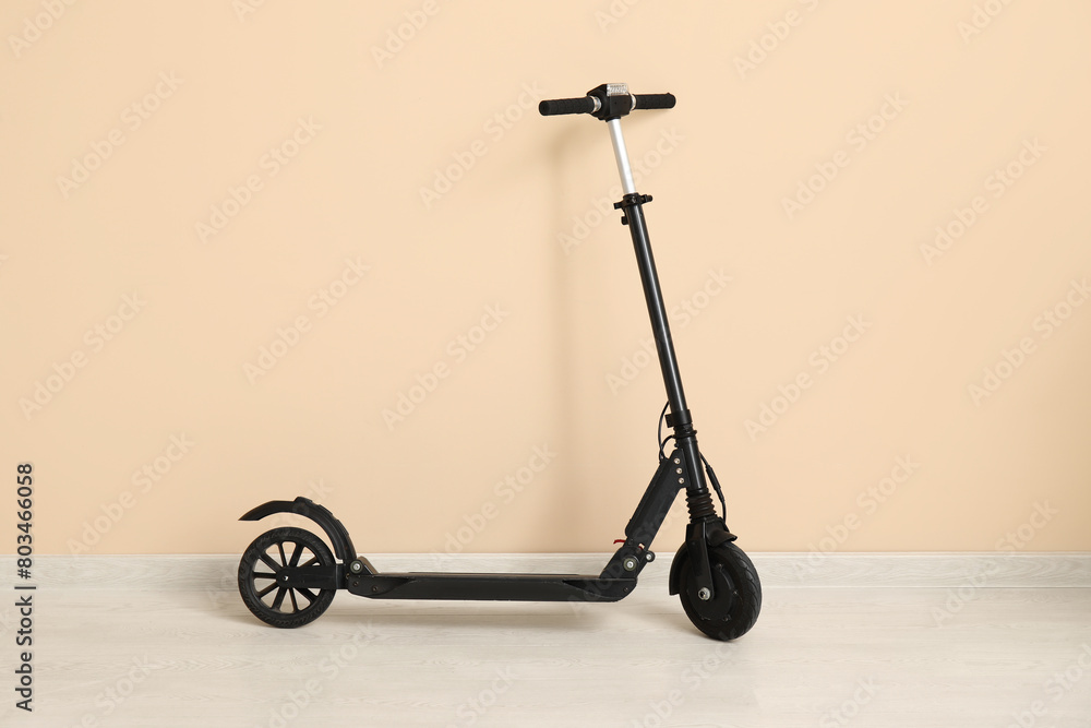 Electric scooter near beige wall in room Electric scooter near beige wall in room