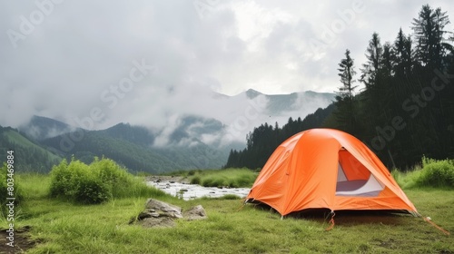 Tent Pitched in Field With Mountain Background