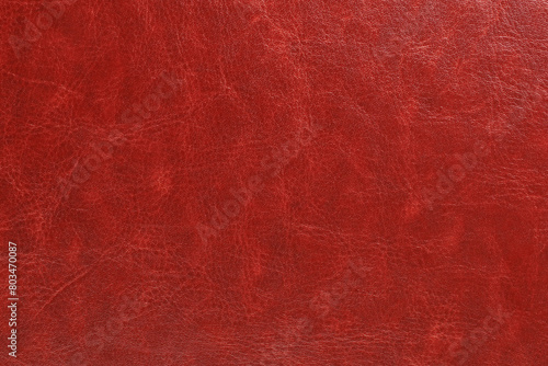 A red leather surface with grainy texture