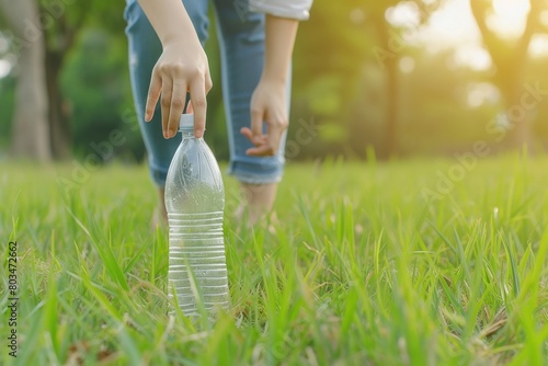 Woman Picks Up Plastic Water Bottle