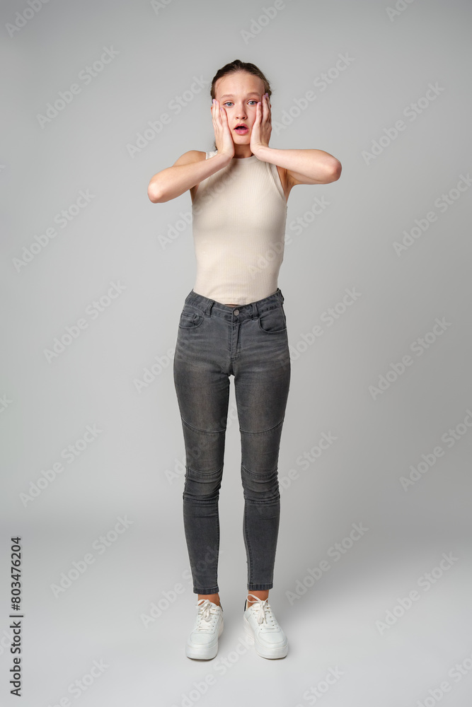 Startled Woman With Surprised Expression on gray background Startled Woman With Surprised Expression on gray background