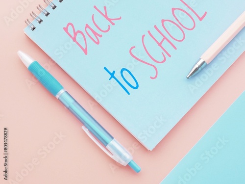 Blue and pink back to school poster with notebook and pens © MissPic