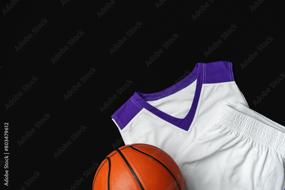 Close-Up of Basketball and White and Purple Jersey on a Black Background Close-Up of Basketball and White and Purple Jersey on a Black Background