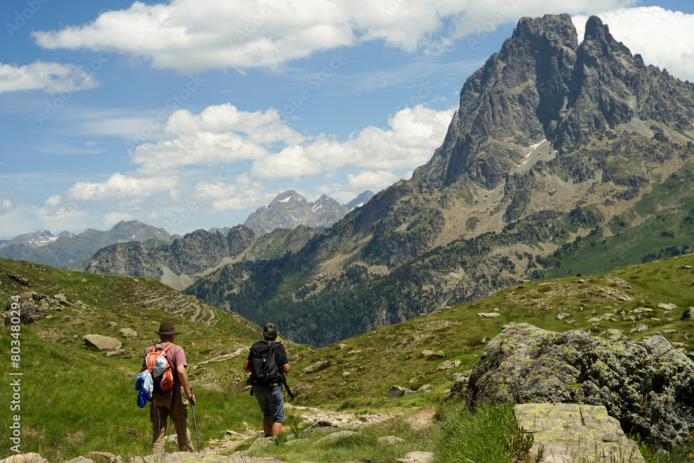 Middle aged couple hiking in beautiful mountains in Pyrenees (Lacs d' Ayous), popular hiking route, France