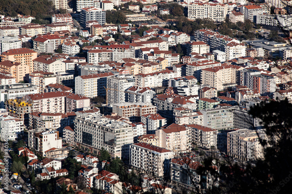 Obraz premium The tourist town of Budva in Montenegro from an aerial view. View on the roofs of houses. Horizontal.