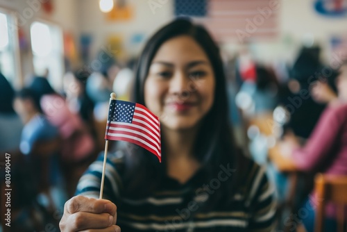 Happy smiling Female immigrant holding a small US flag the day of her naturalization ceremony photo