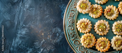 Arabic desserts. Traditional maamoul cookies for Eid made with semolina  filled with dates  walnuts  and pistachios. Image captured from above with empty space for text.