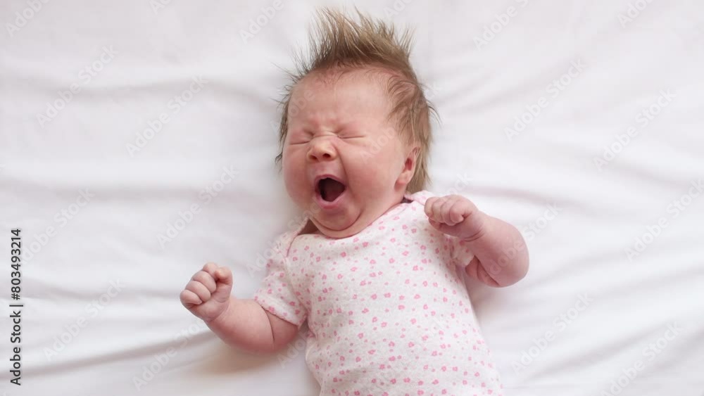 4K video of a Cute Caucasian newborn baby girl yawning at the white background 4K video of a Cute Caucasian newborn baby girl yawning at the white background