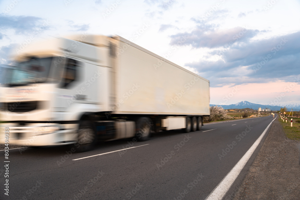 Cargo truck in motion on the road, cargo transportation concept