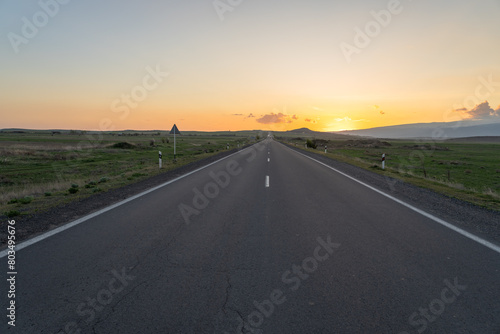 Asphalt road at sunset, travel concept © Daniel