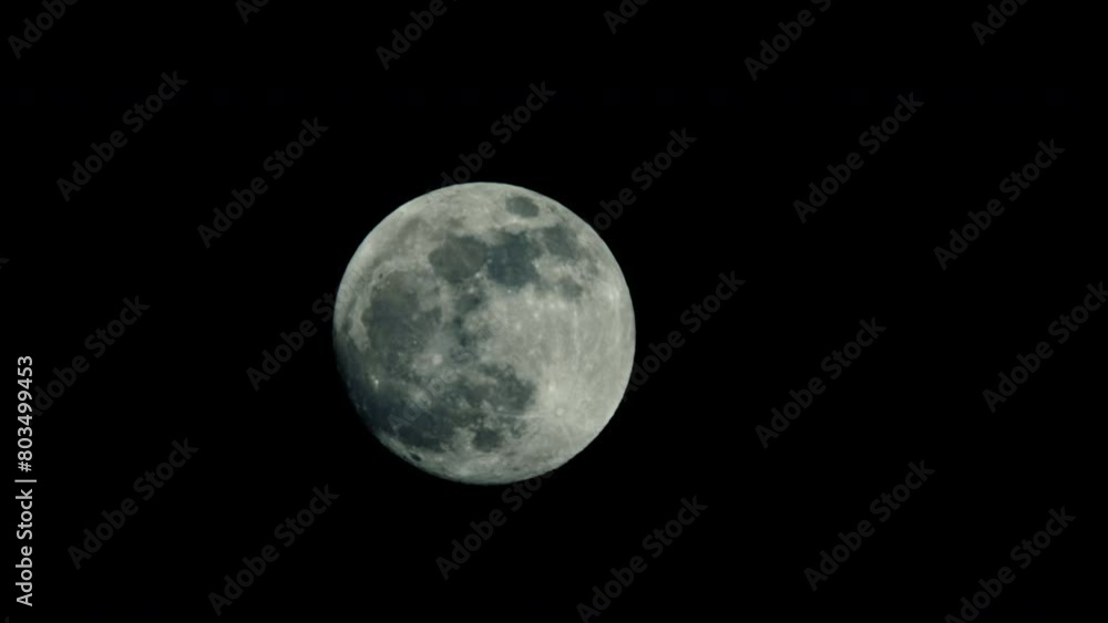 A large full moon moves slowly across the night sky. Slowly but steadily, the moon traverses its celestial path, climbing higher and higher into the night sky. A large full moon moves slowly across the night sky. Slowly but steadily, the moon traverses its celestial path, climbing higher and higher into the night sky.