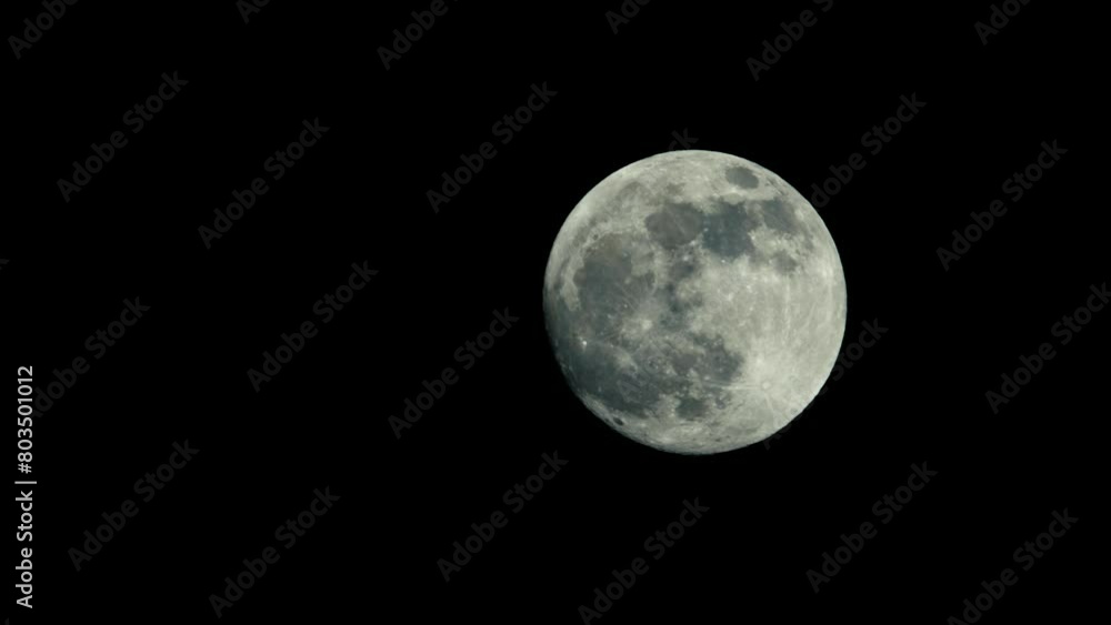 A large full moon moves slowly across the night sky. Finally, as it reaches apex its ascent, moon hovers majestically in the top right corner of the frame, casting its serene light upon world below. A large full moon moves slowly across the night sky. Finally, as it reaches apex its ascent, moon hovers majestically in the top right corner of the frame, casting its serene light upon world below.