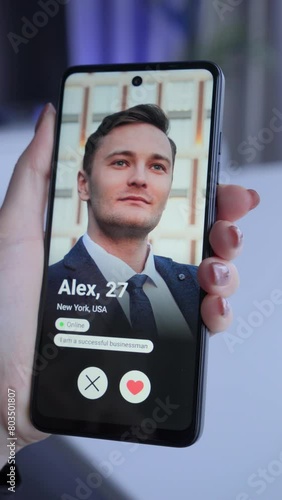 Visual concept of the young woman using dating app on smartphone and gets a match. Woman holding smartphone in hand and looking for a man in a dating app