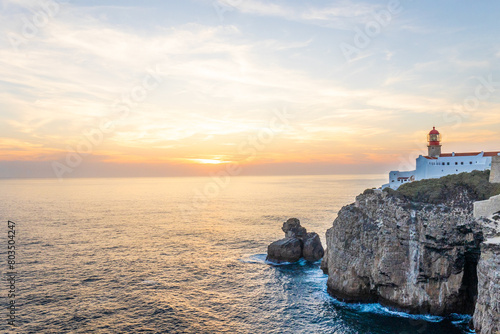 Farol do Cabo de Sao Vincente in Sagres in the Algarve Portugal. Overlooking the blue sea during a beautiful golden sunset photo