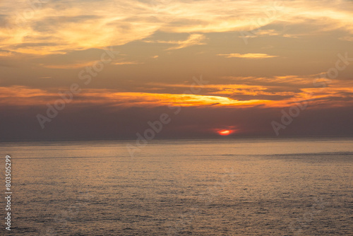 Landscape photo of dramatic  steep orange cliffs by the atlantic at sunset. Shot in Farol fo Cabo de Sao Vincente near Sagres  Portugal.