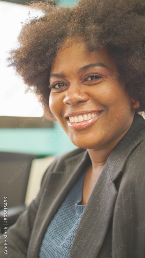 Cheerful businesswoman with a bright smile in an office.