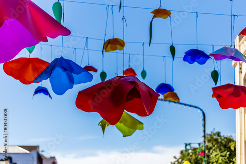 Plastic Flowers Against a Blue Sky, Decorating the Street and Bringing a Touch of Colorful Charm to the Urban Landscape