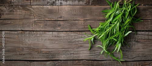Tarragon placed neatly on a wooden surface, top view. Room for adding text