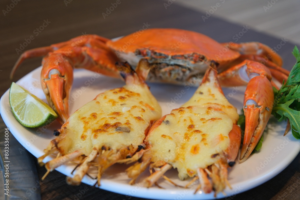 crab and shrimp baked with cheese Delicious grilled lobsters and cheese on white plate