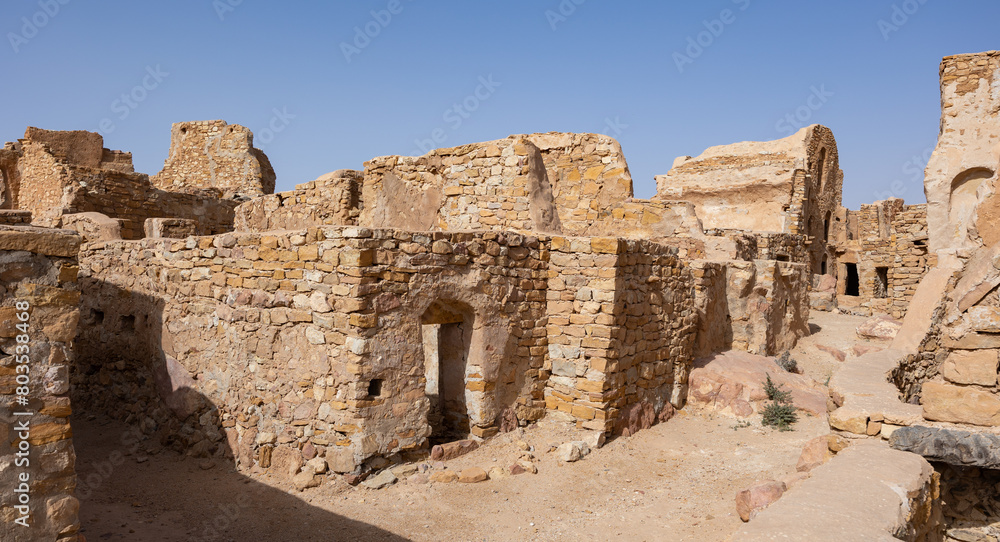 View of old Ksar Beni Barka settlement with ruined storage areas in Tunisia